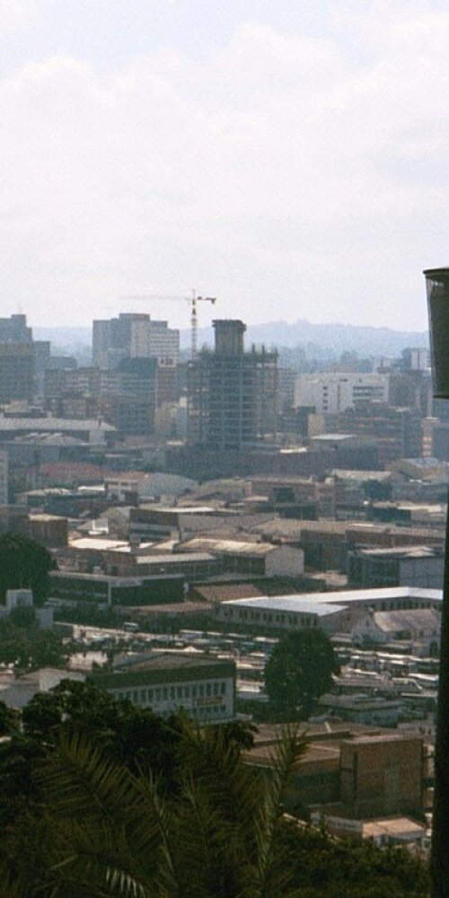 Street scene in Harare with buses and pedestrians